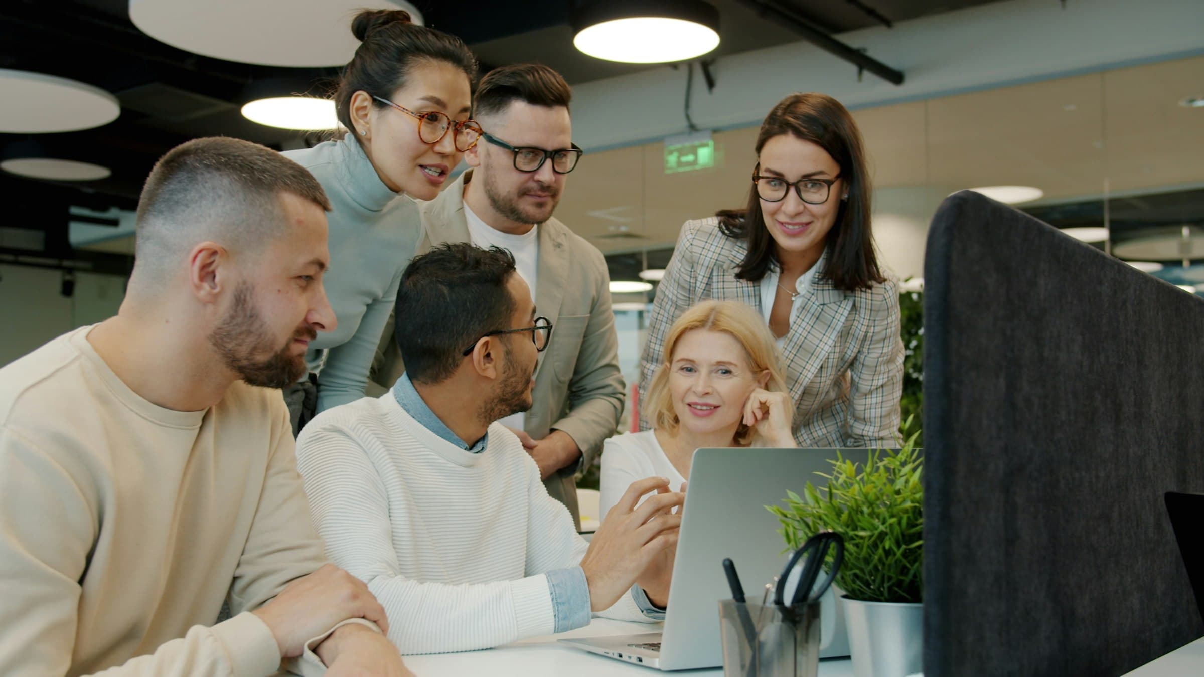 A small team gathered around a table, mid-discussion